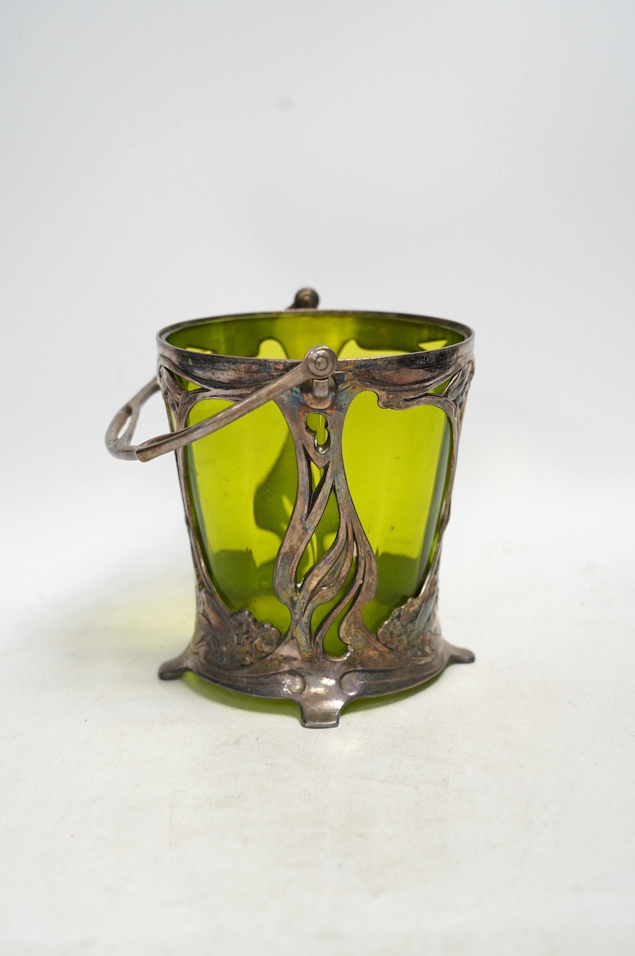 An Art Nouveau WMF pewter mounted biscuit jar with glass liner, lacking cover, stamped to the base, 23cm high including handle. Condition - fair